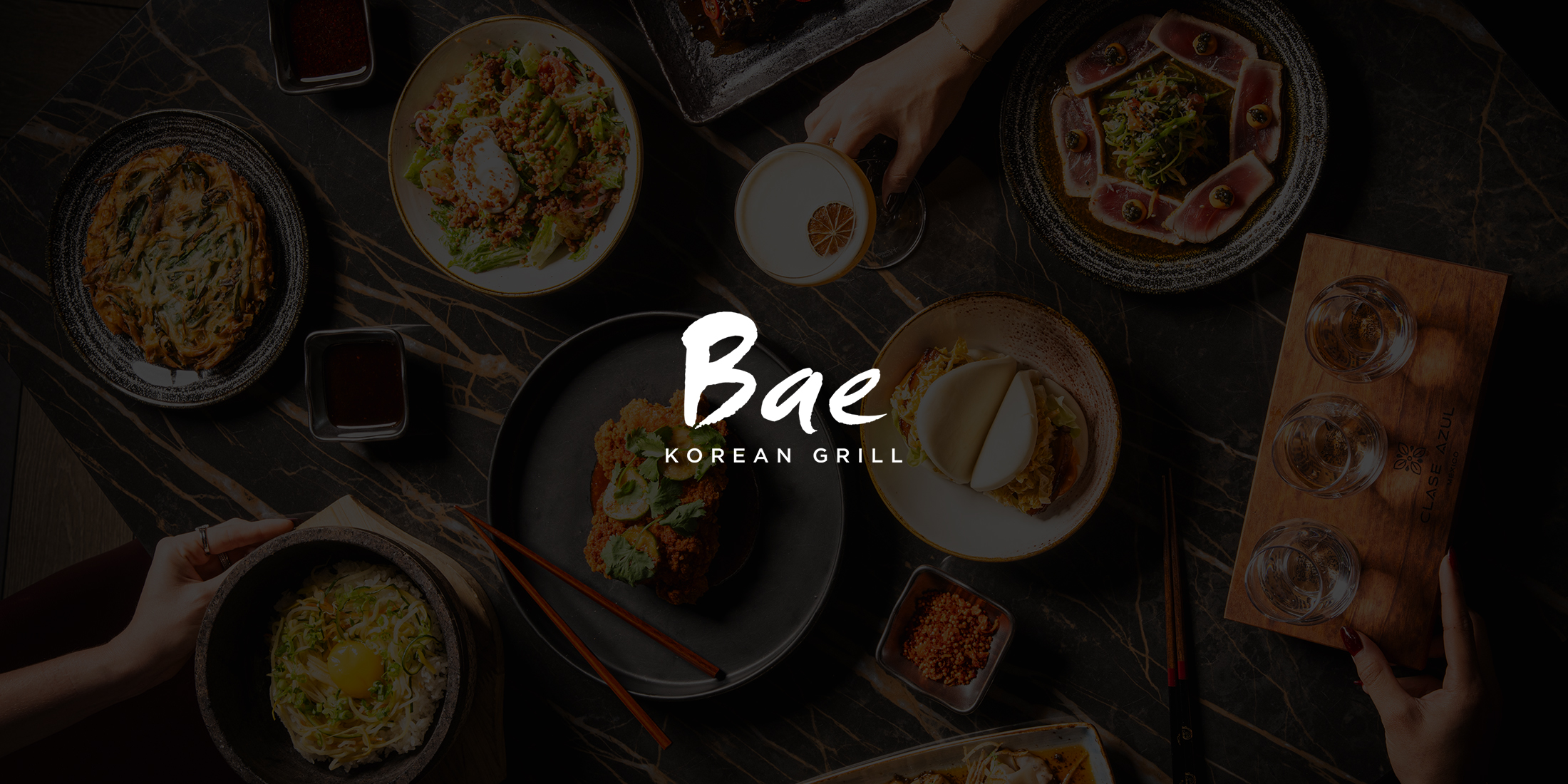 table full of food and drinks at bae grill in the hard rock hotel