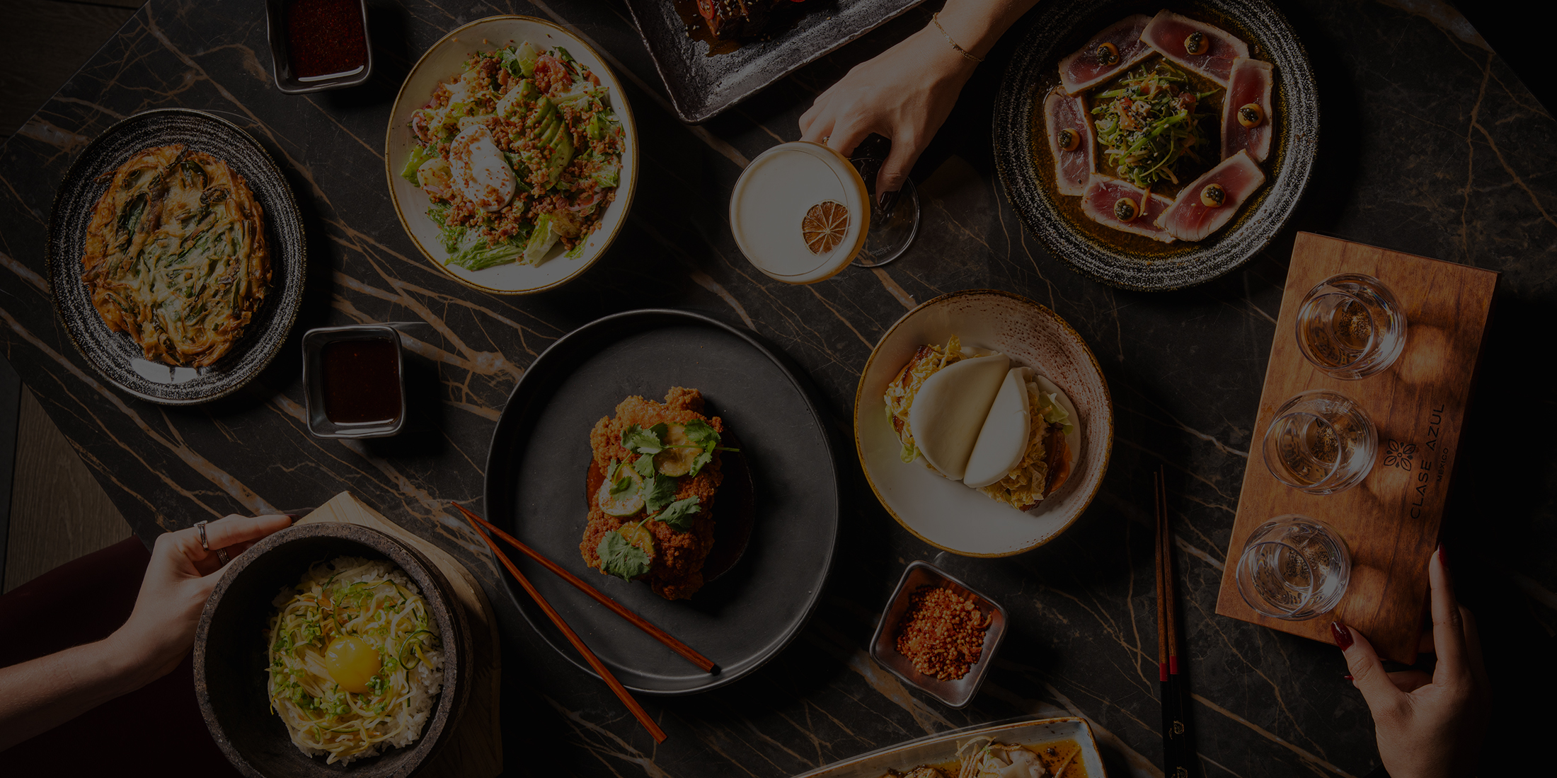 overhead view of table with food and drinks at bae korean grill